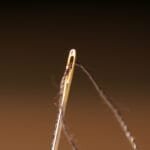 Sewing needle eye with thread a sewing needle
